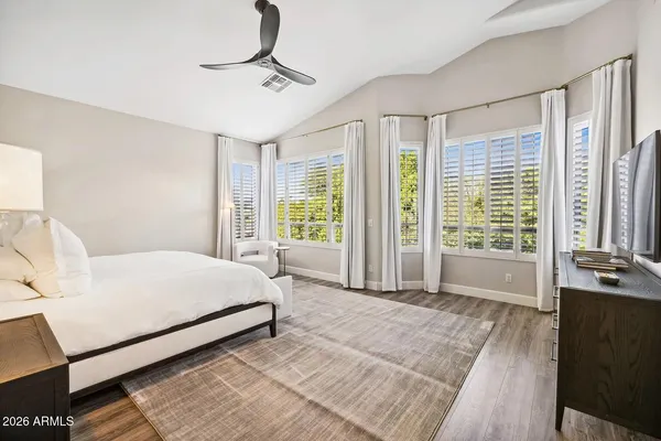 a bedroom with a bed lamp and a window