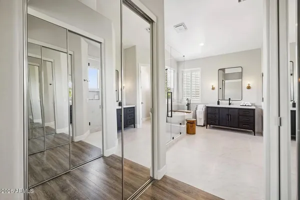 a bathroom with a tub sink and mirror