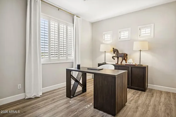 a bedroom with bed table and window