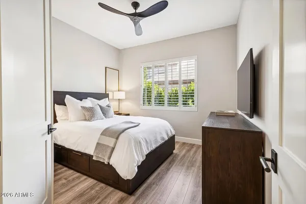 a bedroom with a bed and wooden floor