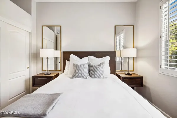 a bedroom with bed and a night stand