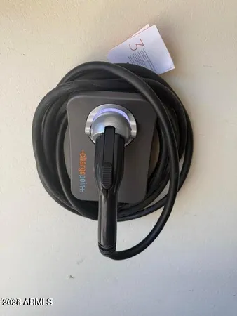 a backyard of a house with table and chairs under an umbrella