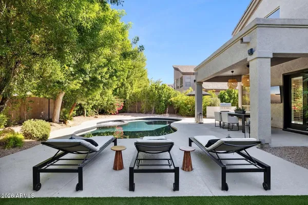 a view of a backyard with sitting area
