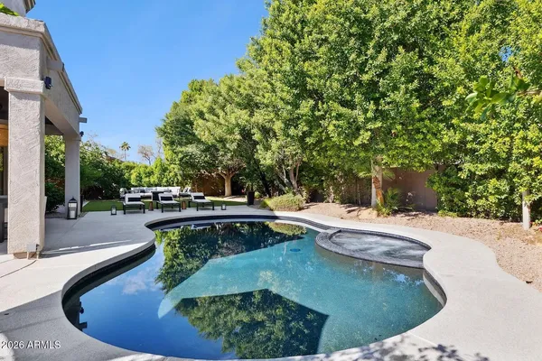 an aerial view of a house with a yard and trees