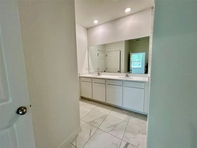 a bathroom with a granite countertop sink