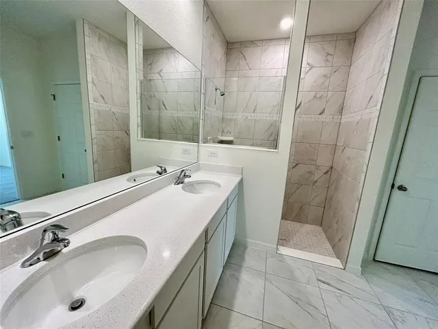 a bathroom with a glass door shower