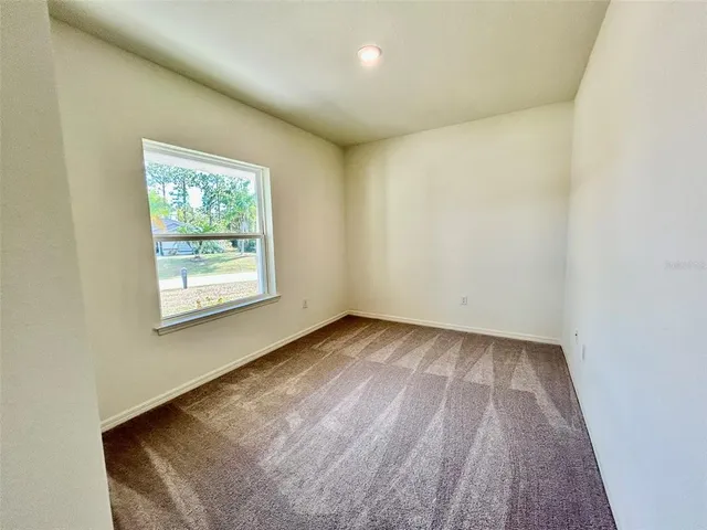 a bathroom with a granite countertop toilet a sink and a mirror
