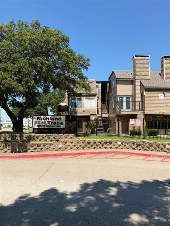 9815 Walnut Street, Unit 102 Dallas, TX 75243 - Photo 2 of 13 Multi-level residential building featuring tan siding and multiple pitched roofs