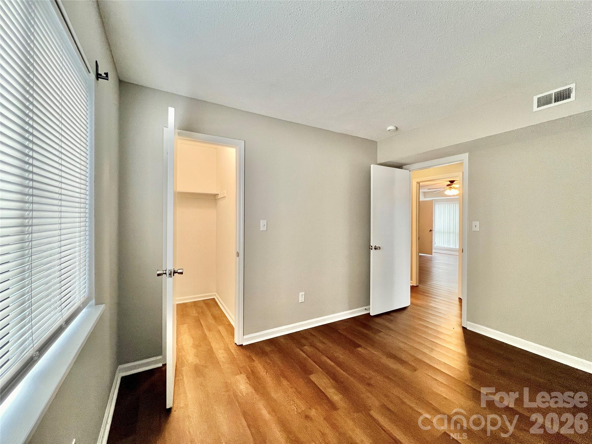 11084 Harrowfield Road Charlotte, NC 28226 - Photo 21 of 31 a view of wooden floor in an empty room with a window