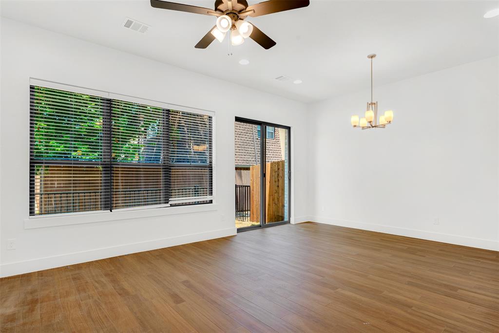 3676 Rickshaw Drive, Unit A Dallas, TX 75229 - Photo 9 of 21 Spacious open-concept living and dining area with luxury vinyl flooring. Patio doors open to small fenced patio.Thick door/curtain covering