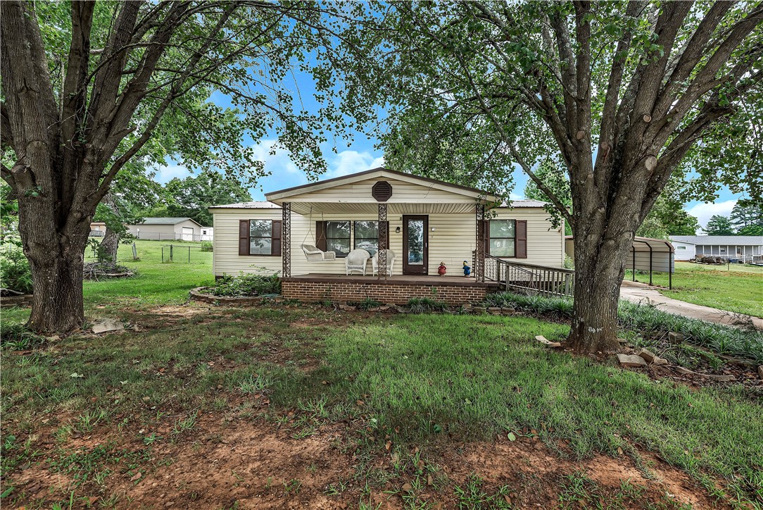 1004 Wiles Road Anderson, SC 29625 - Photo 1 of 26 A charming single-story residence with a welcoming front porch, nestled amidst mature shade trees.