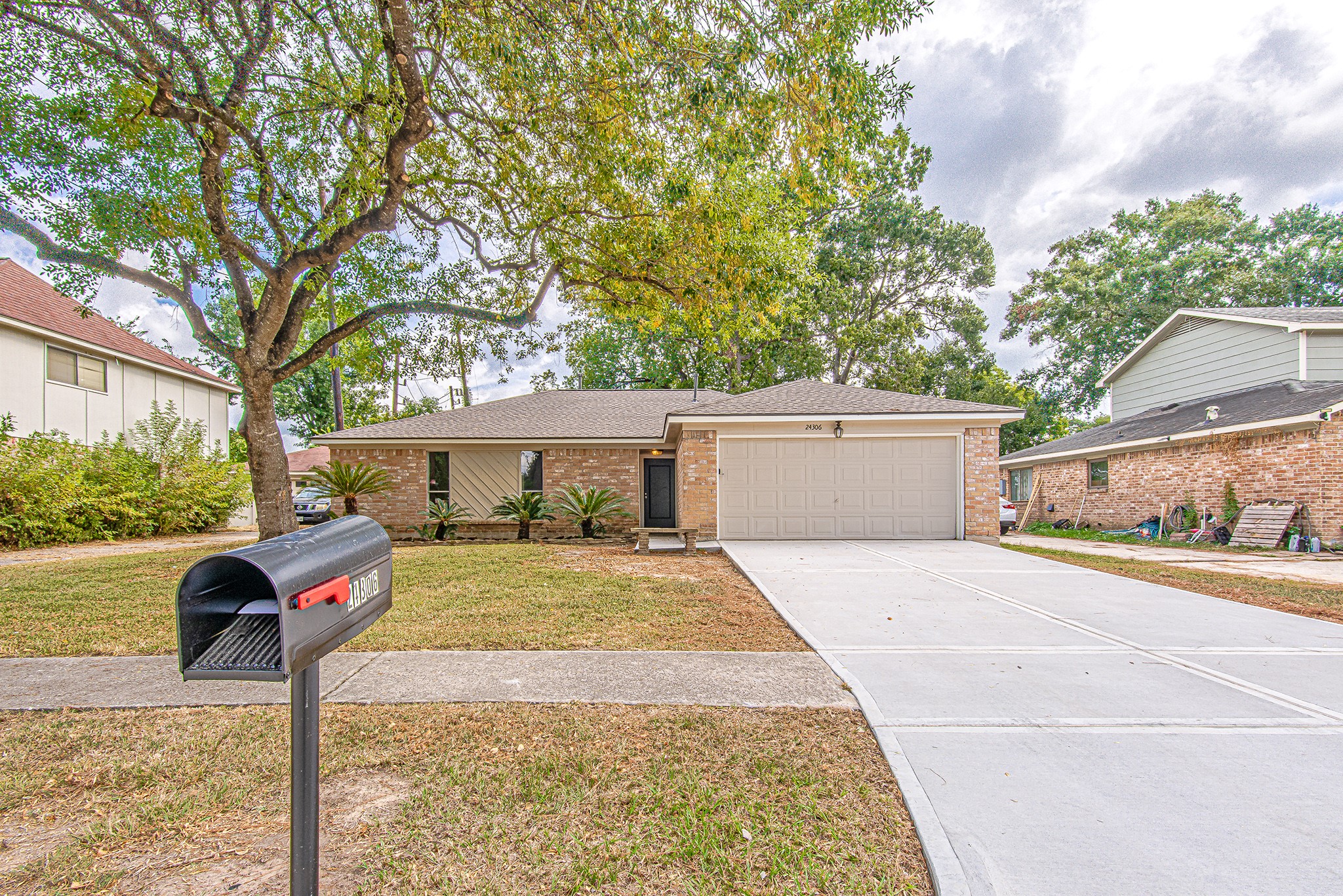 24306 Spring Mill Lane Spring, TX 77373 - Photo 1 of 24 a front view of a house with a yard and garage