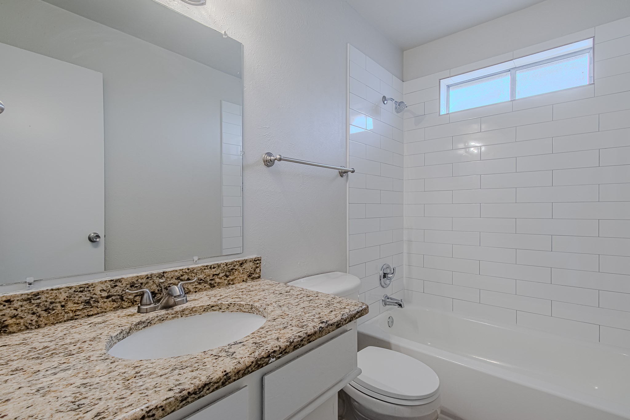24306 Spring Mill Lane Spring, TX 77373 - Photo 19 of 24 a bathroom with a granite countertop sink toilet and shower