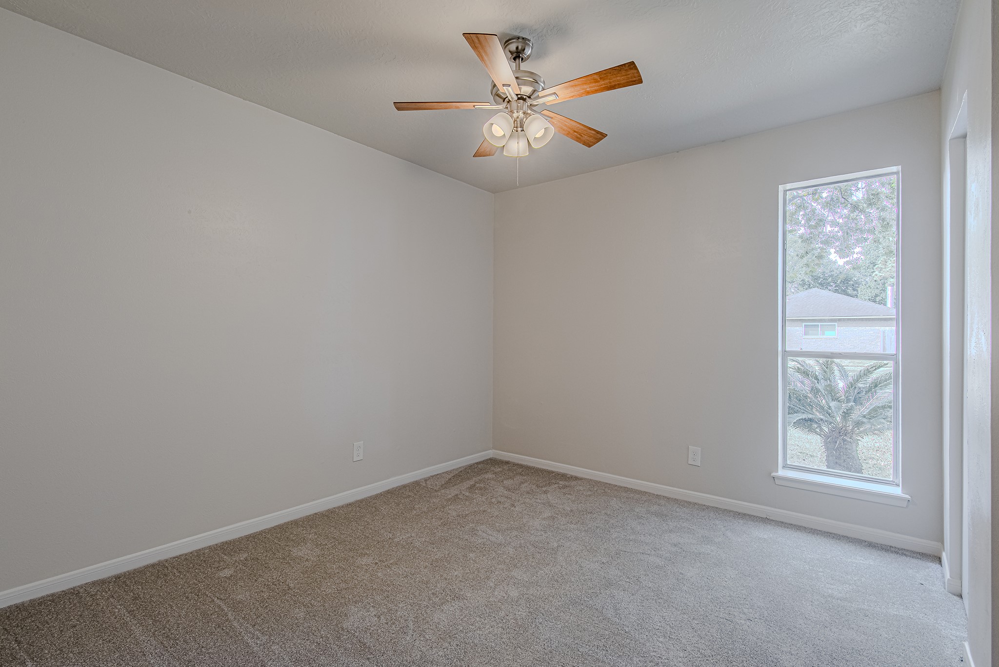 24306 Spring Mill Lane Spring, TX 77373 - Photo 20 of 24 an empty room with windows and fan