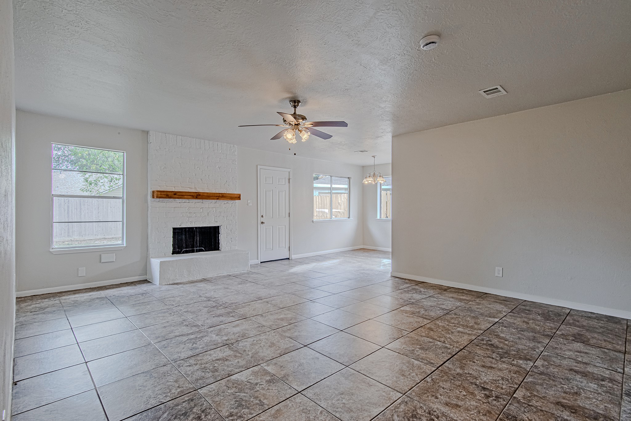 24306 Spring Mill Lane Spring, TX 77373 - Photo 6 of 24 a view of an empty room with a fireplace and a window