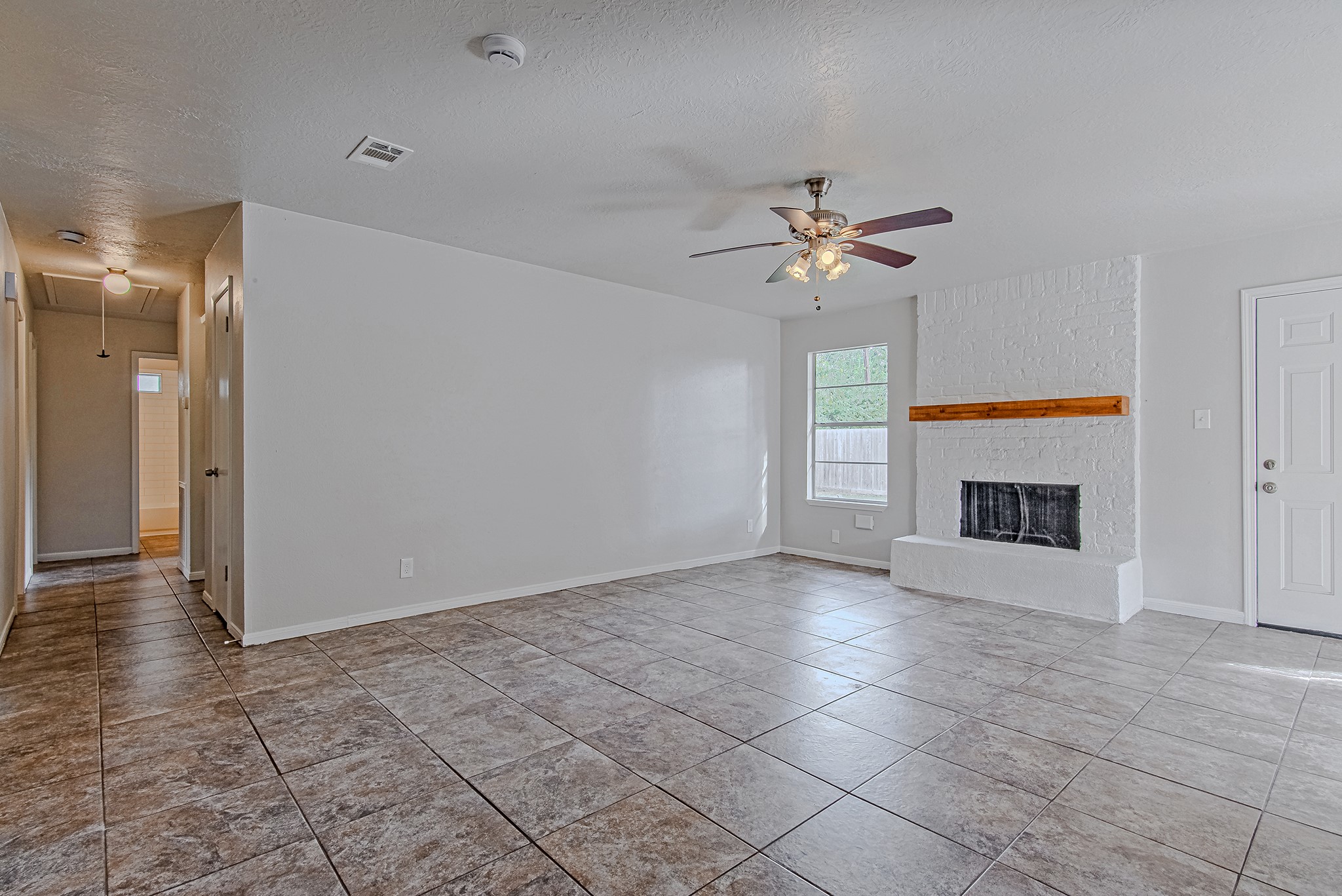 24306 Spring Mill Lane Spring, TX 77373 - Photo 8 of 24 a view of an empty room with a fireplace