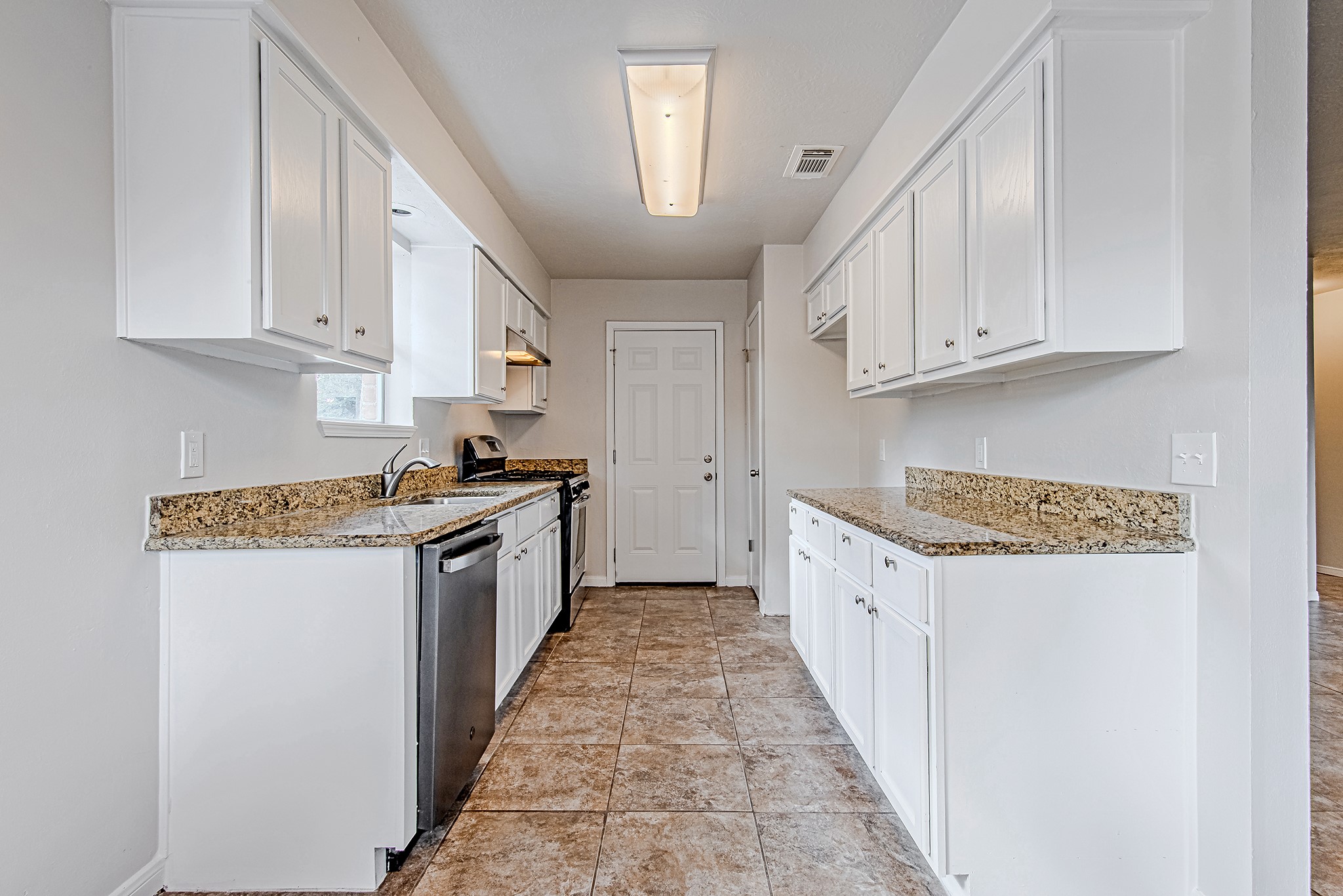 24306 Spring Mill Lane Spring, TX 77373 - Photo 9 of 24 a kitchen with granite countertop a sink a counter top space and cabinets