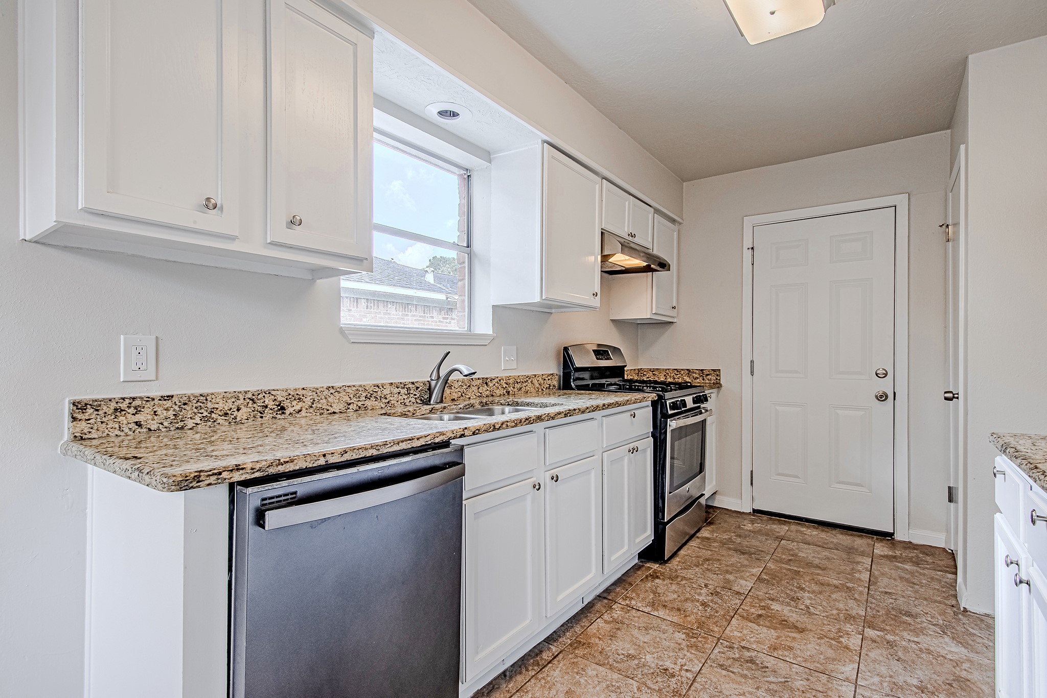 24306 Spring Mill Lane Spring, TX 77373 - Photo 10 of 24 a kitchen with stainless steel appliances granite countertop a sink stove and cabinets