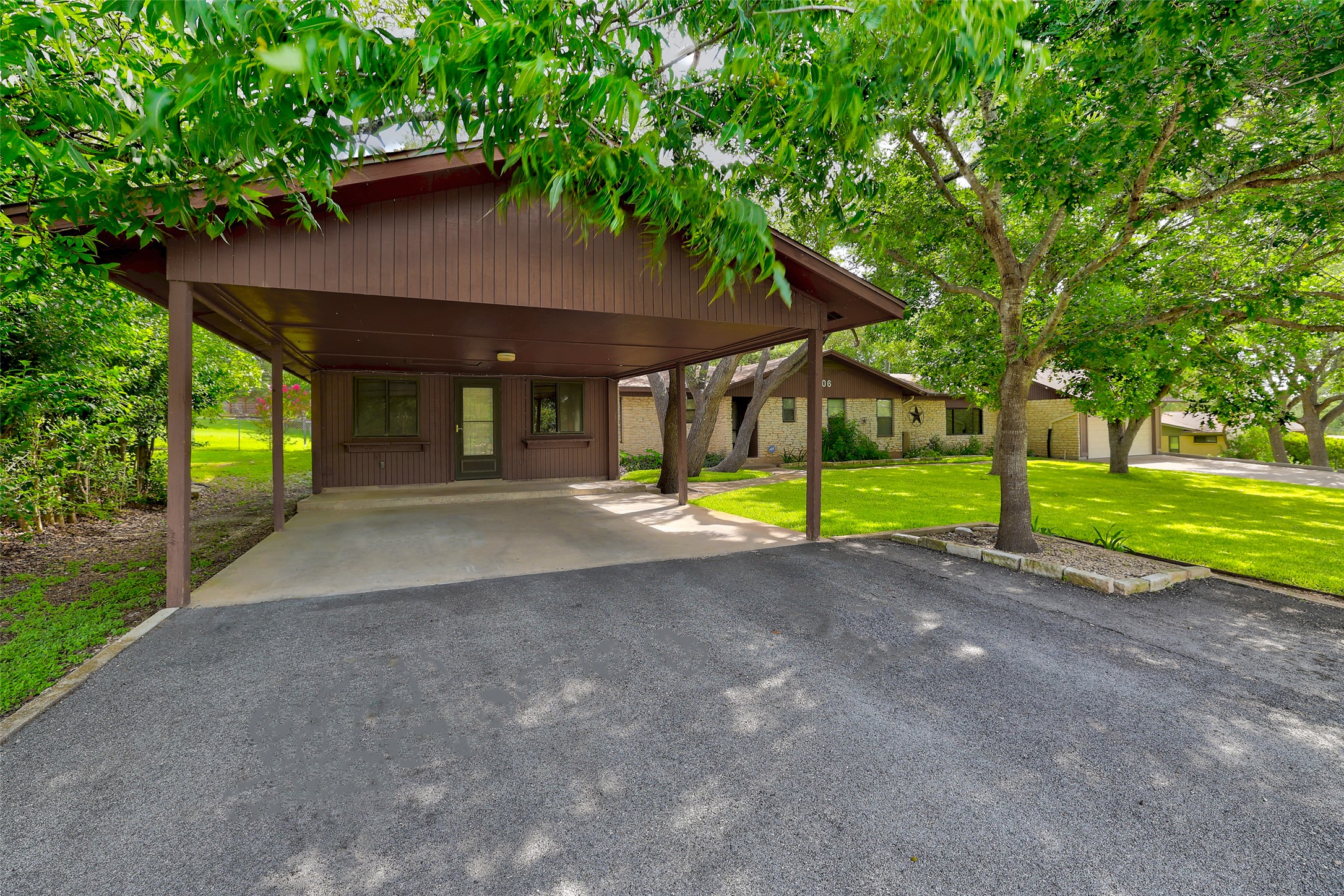 8606 Thunderbird Road, Unit A & B Austin, TX 78736 - Photo 26 of 34 A welcoming carport provides shelter and convenient access to this charming single-story residence.