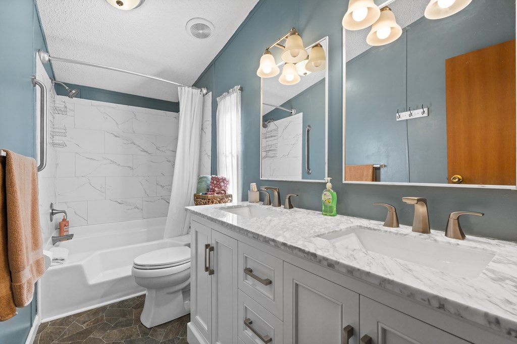 39 Red Bush School Road Blue Ridge, GA 30513 - Photo 22 of 36 a bathroom with a granite countertop sink mirror vanity and toilet