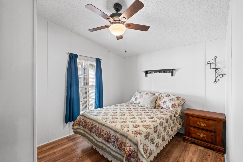 39 Red Bush School Road Blue Ridge, GA 30513 - Photo 23 of 36 a bedroom with a bed and a chandelier