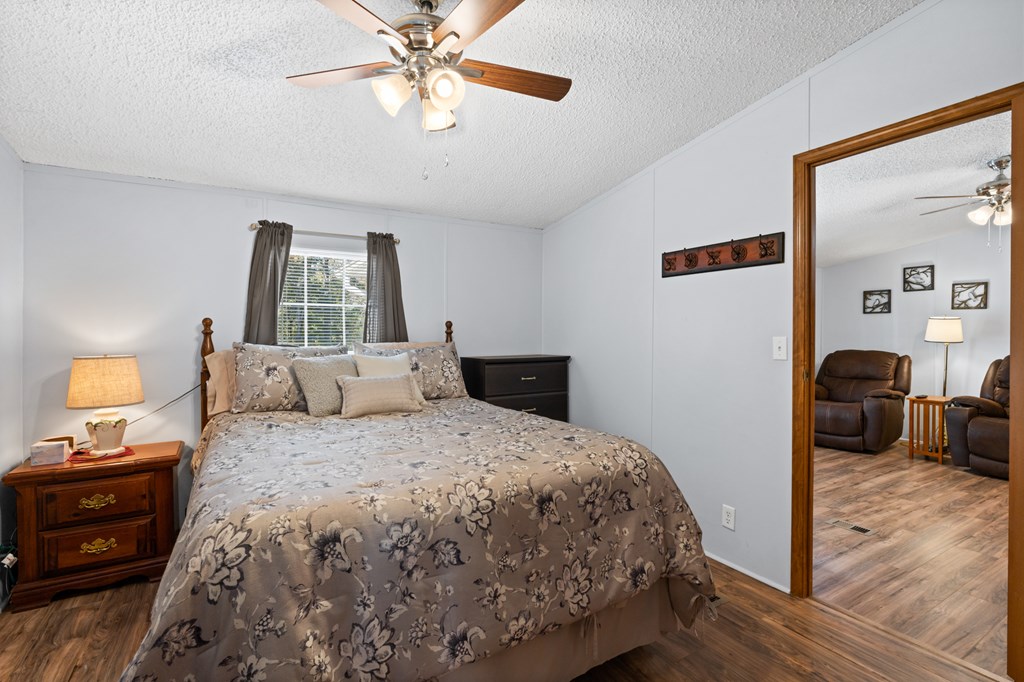 39 Red Bush School Road Blue Ridge, GA 30513 - Photo 29 of 36 a bedroom with a bed and wooden floor