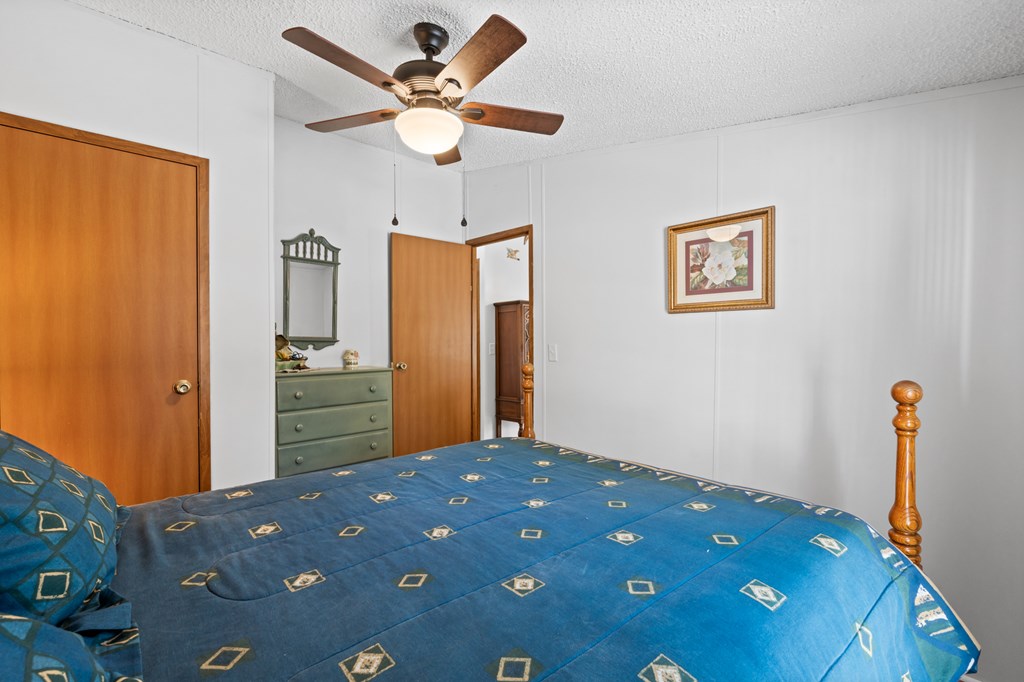 39 Red Bush School Road Blue Ridge, GA 30513 - Photo 33 of 36 a bedroom with a bed and a chandelier