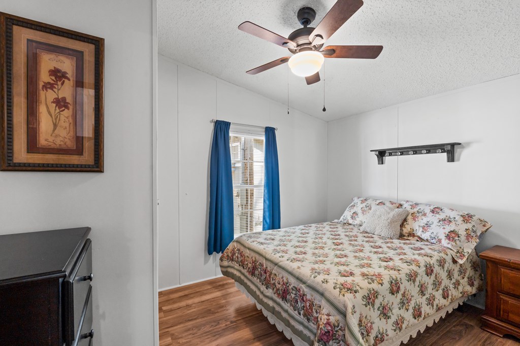 39 Red Bush School Road Blue Ridge, GA 30513 - Photo 34 of 36 a bedroom with a large bed and a chandelier