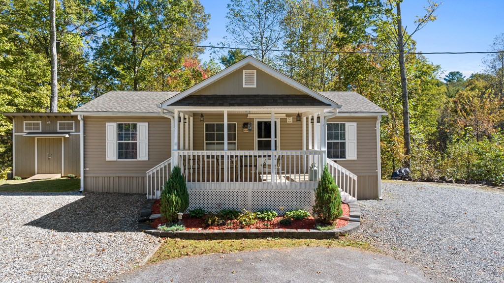 39 Red Bush School Road Blue Ridge, GA 30513 - Photo 6 of 36 a front view of a house with a garden