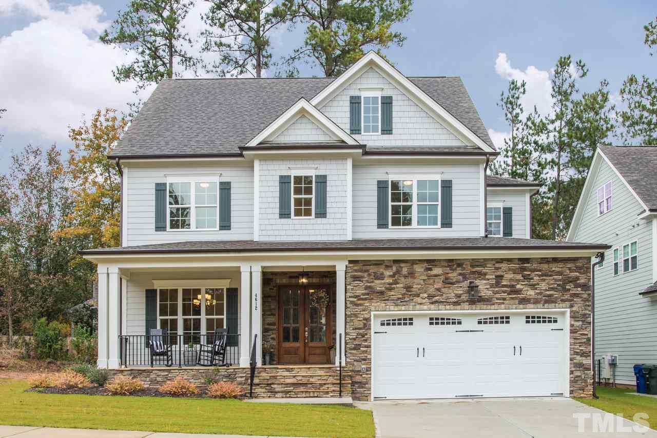 4612 Pleasant Pointe Way Raleigh, NC 27613 - Photo 1 of 25 a front view of a house with a yard and garage