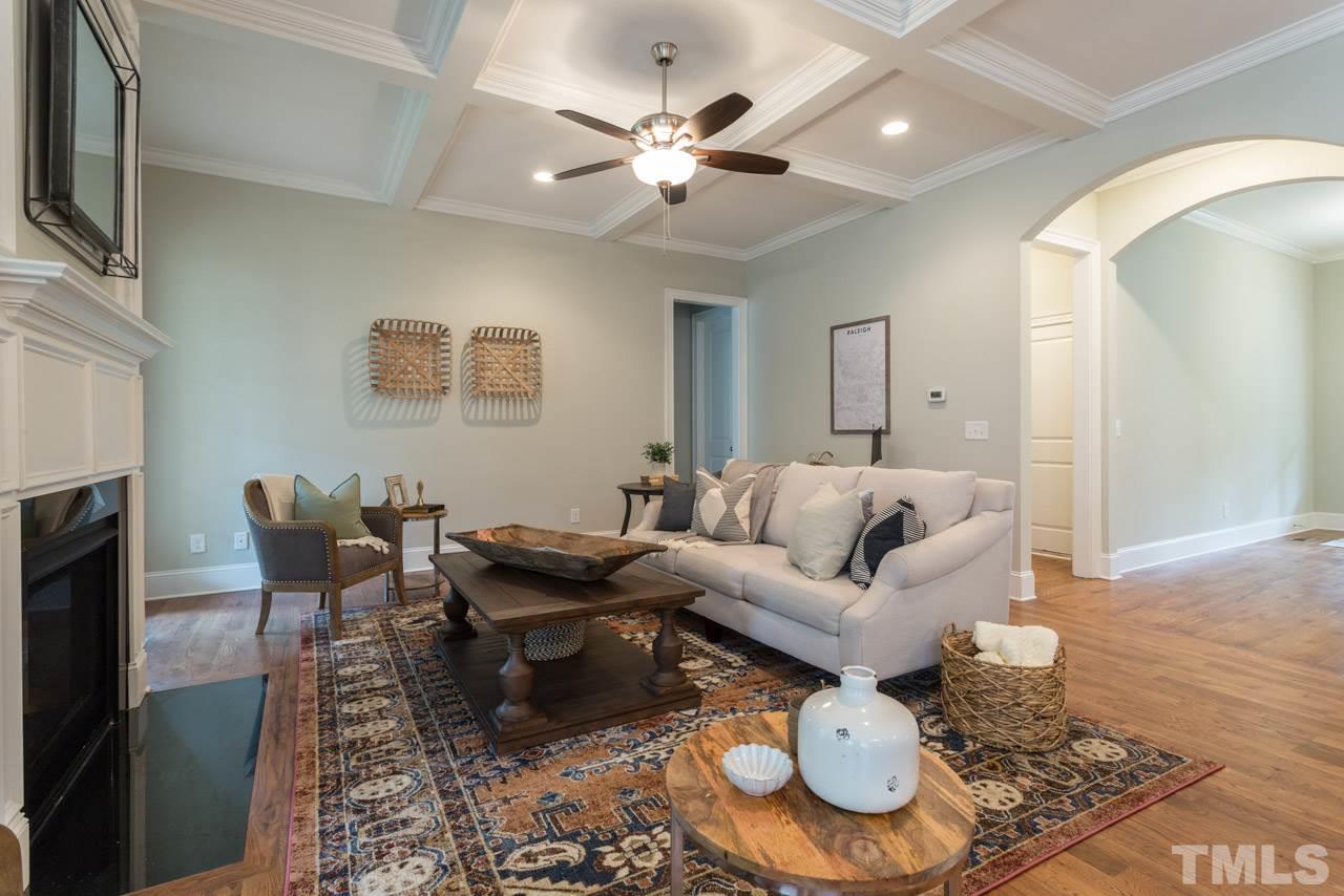 4612 Pleasant Pointe Way Raleigh, NC 27613 - Photo 11 of 25 a living room with furniture a rug and a fireplace