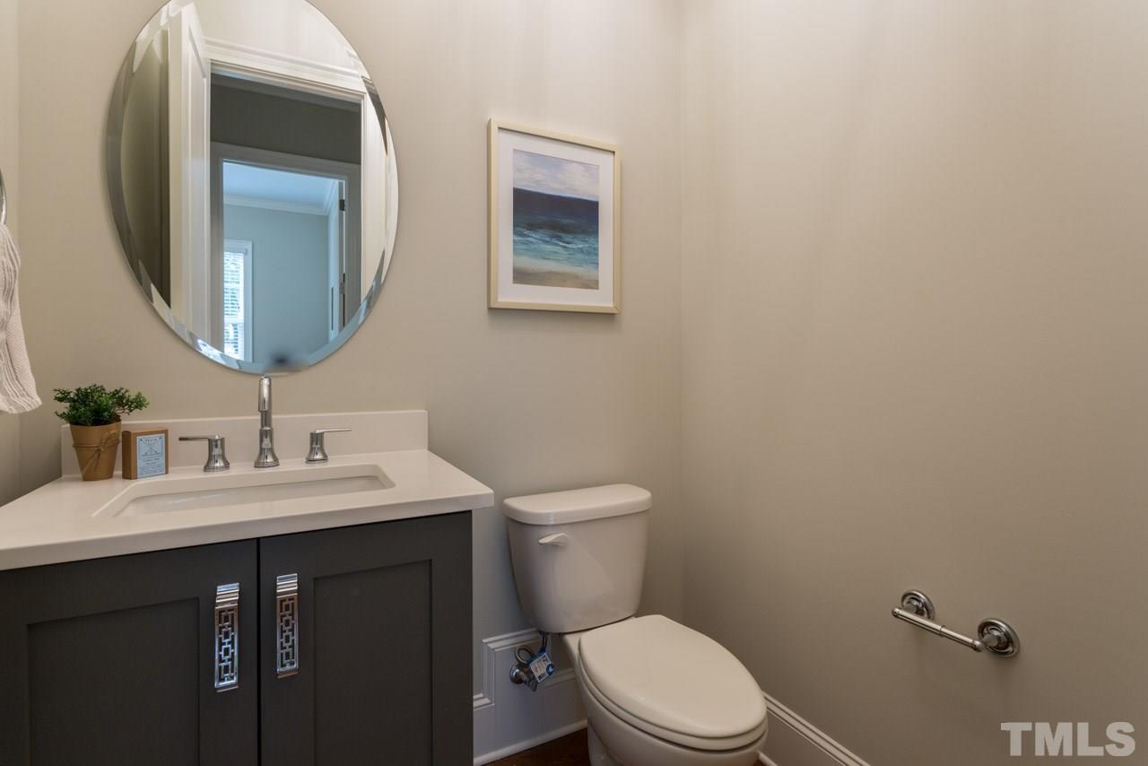 4612 Pleasant Pointe Way Raleigh, NC 27613 - Photo 12 of 25 a bathroom with a toilet a sink and mirror