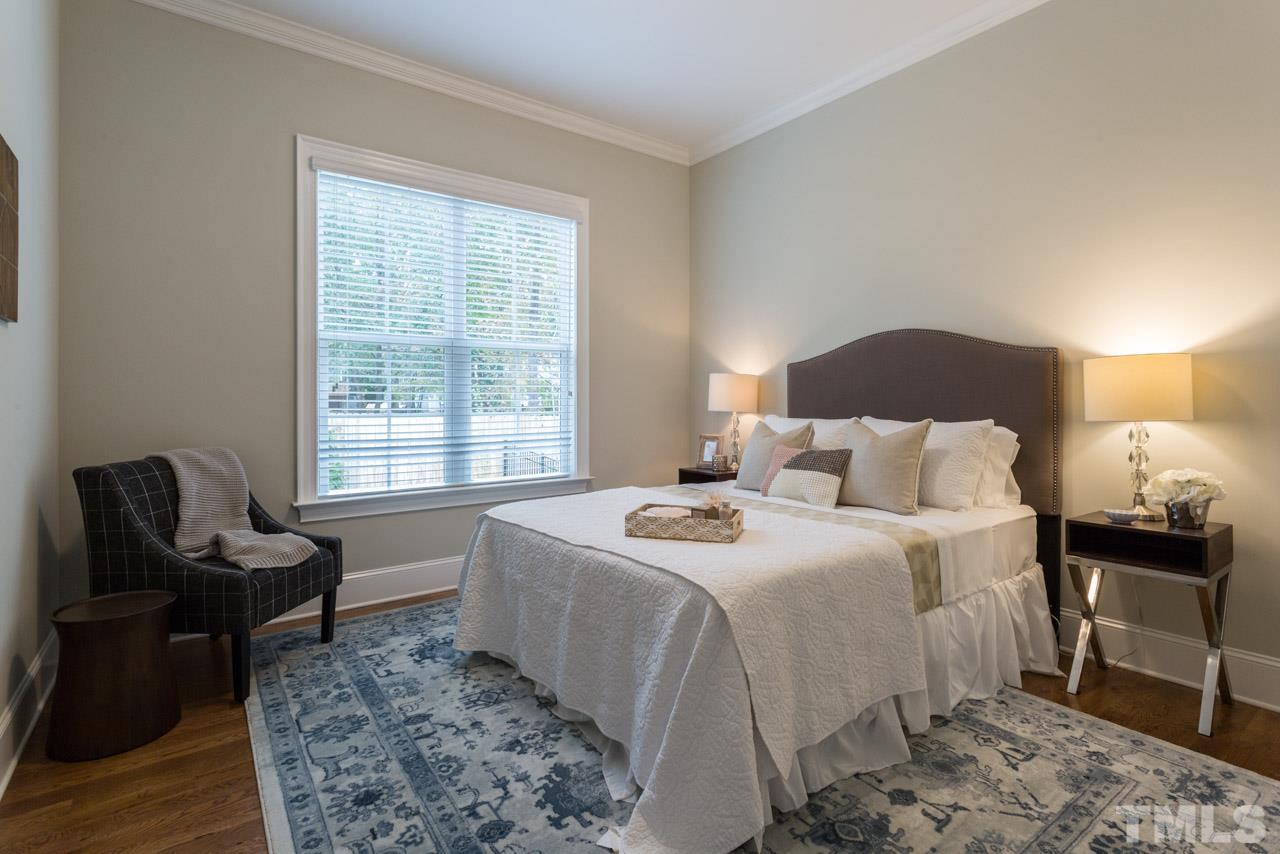 4612 Pleasant Pointe Way Raleigh, NC 27613 - Photo 13 of 25 a bedroom with a bed and wooden floor