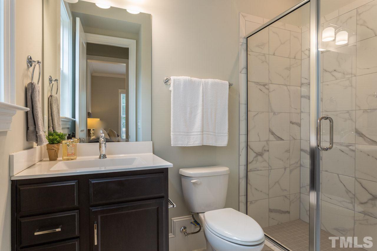 4612 Pleasant Pointe Way Raleigh, NC 27613 - Photo 14 of 25 a bathroom with a sink a toilet and shower