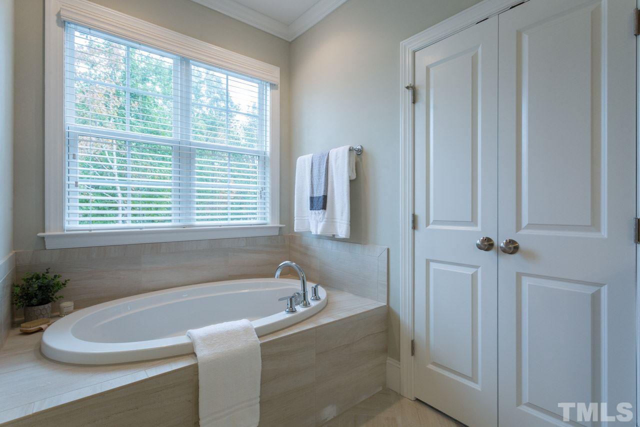 4612 Pleasant Pointe Way Raleigh, NC 27613 - Photo 18 of 25 a white bath tub sitting next to a window