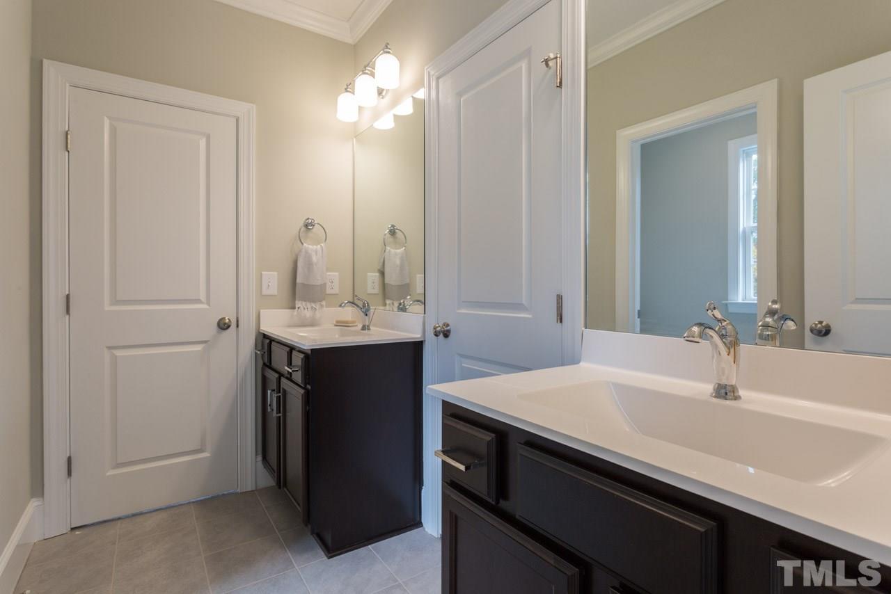 4612 Pleasant Pointe Way Raleigh, NC 27613 - Photo 22 of 25 a bathroom with a sink and a mirror