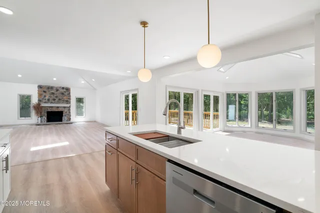 an empty room with windows and fireplace