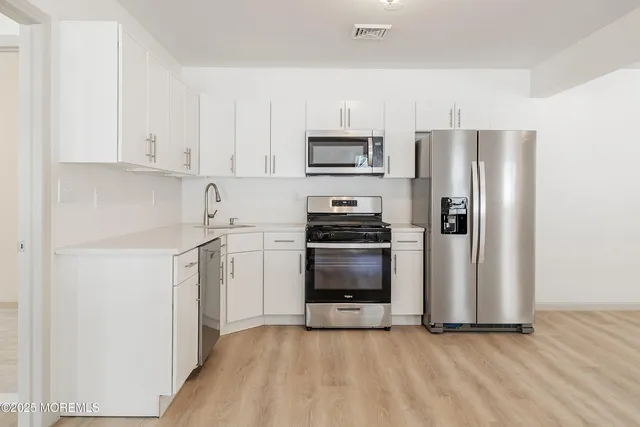 an empty room with wooden floor and painted walls