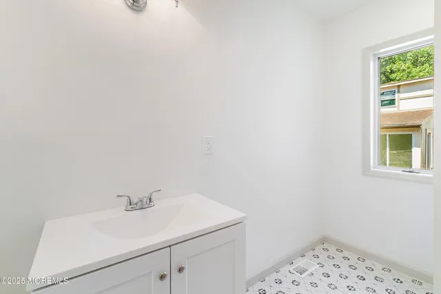 a view of staircase with white walls and a window