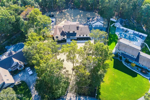 a view of a house with a yard and large tree