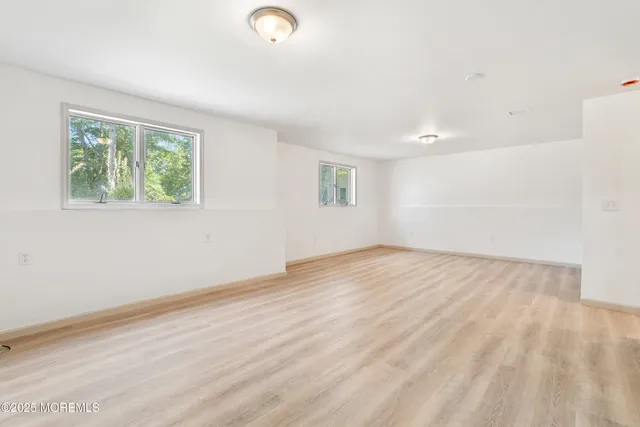 a white bath tub sitting next to a shower