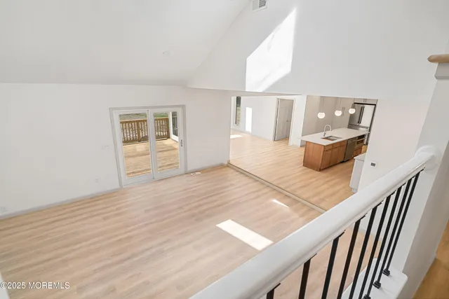 a view of a balcony with wooden floor and fence