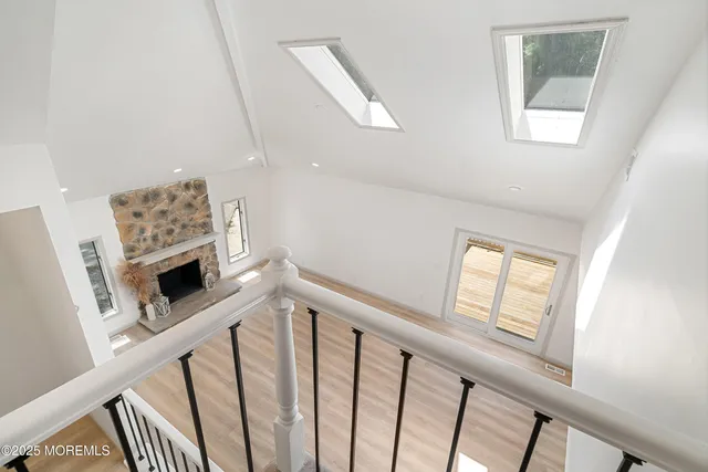a view of a balcony with two plants and a barbeque