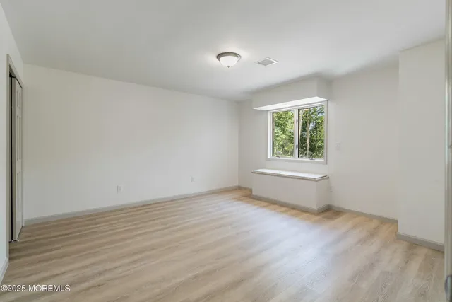 a picture of a room with a white wall and a painting