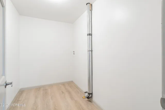 a black and white photo of a bench