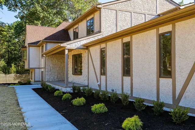 a kitchen with stainless steel appliances granite countertop a sink a stove and a wooden floors