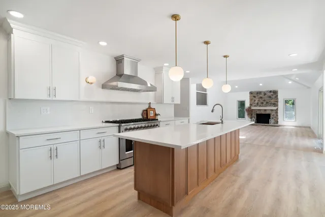an empty room with wooden floor a fireplace and window