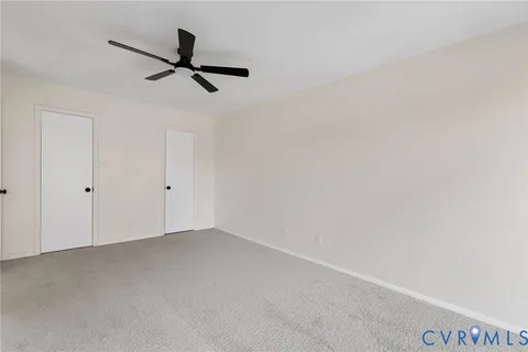 a view of a room with a ceiling fan
