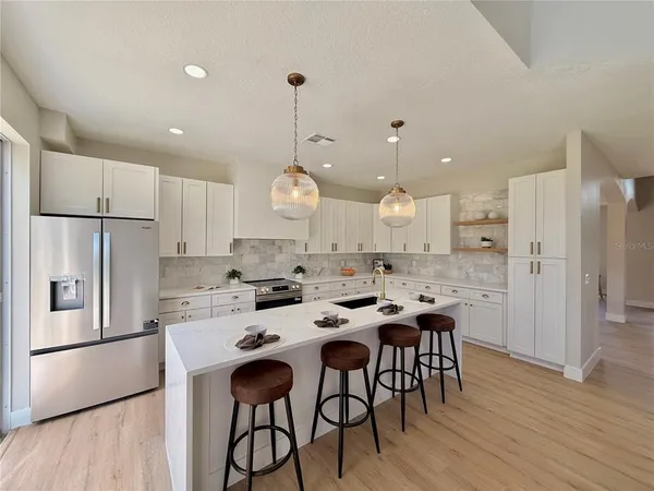 a living room with fireplace furniture and a floor to ceiling window