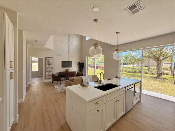 a spacious bathroom with a tub sink and mirror